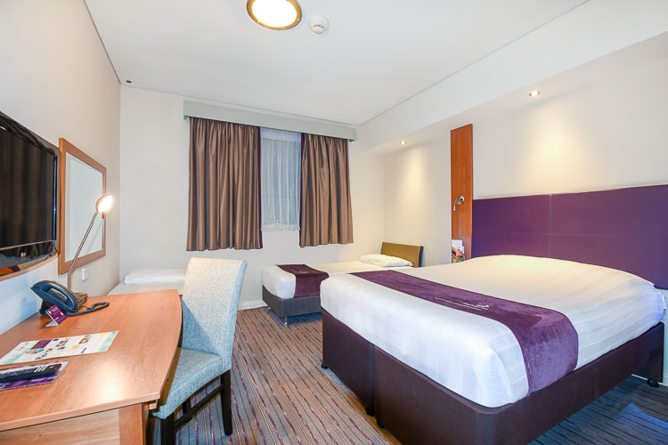 Family room with desk and private bathroom at Premier Inn hotel in Dubai Silicon Oasis