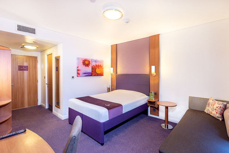 Double bedroom with sofa bed and desk at Premier Inn Abu Dhabi International Airport hotel 