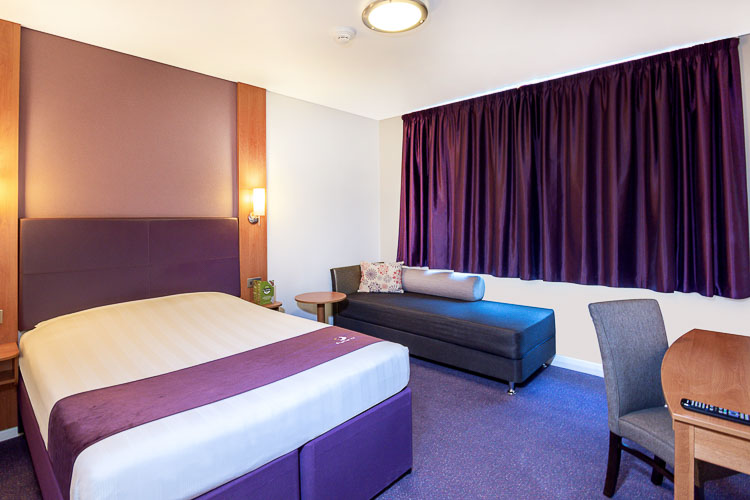Double room with sofa bed and desk at Premier Inn Abu Dhabi International Airport hotel in Abu Dhabi