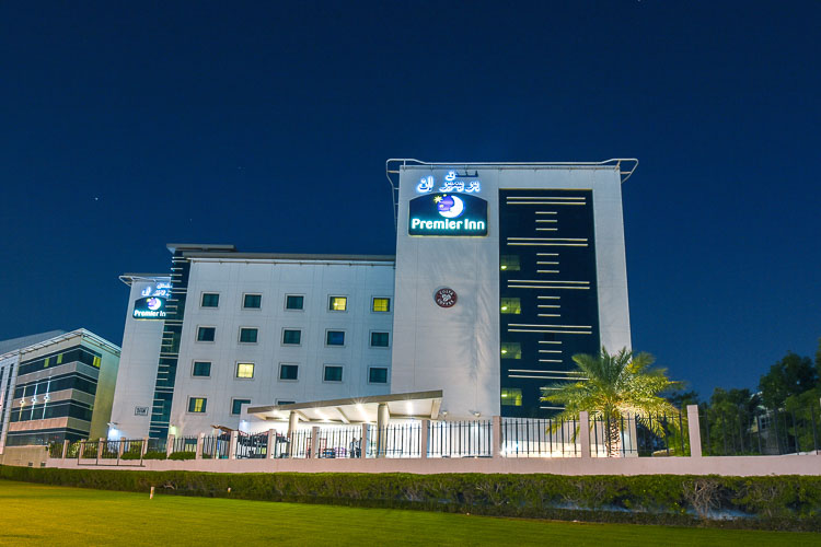 Exterior of Premier Inn Dubai International Airport hotel at night time in Dubai