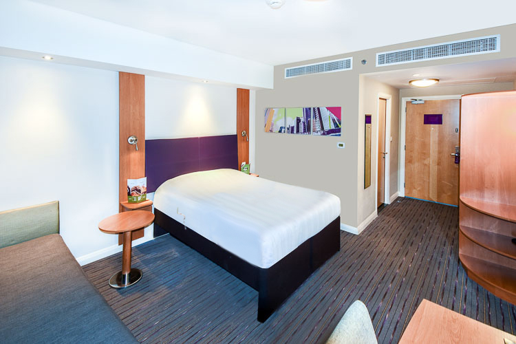 A double room with large bed and a sofa bed at Premier Inn Dubai International Airport hotel