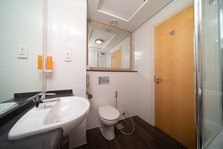 Ensuite bathroom with bath and shower in Premier Inn Dubai Investments Park
