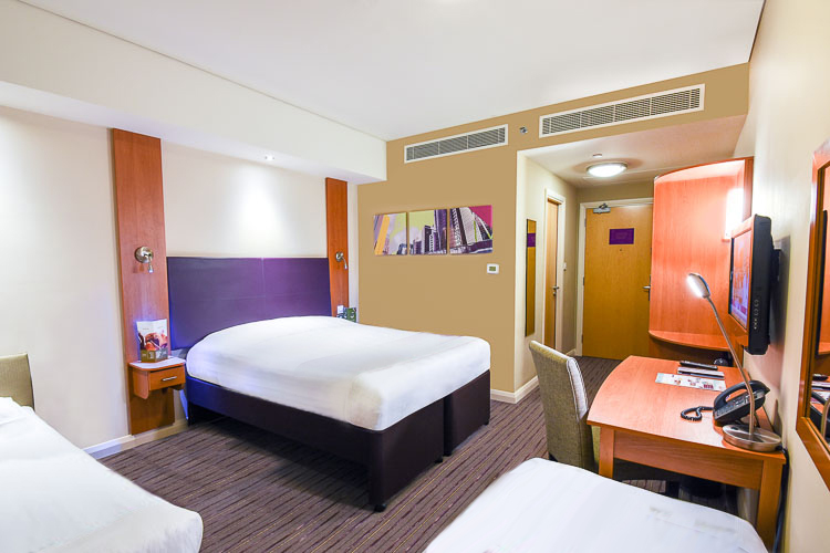 Family room with double bed and two single beds at Premier Inn Dubai International Airport hotel