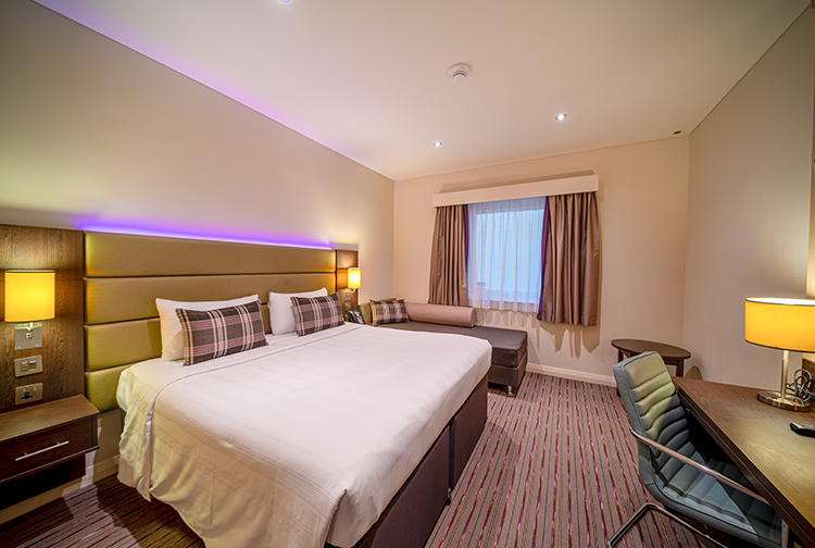 Large double bedroom with sofa and desk in Premier Inn hotel in Dubai 