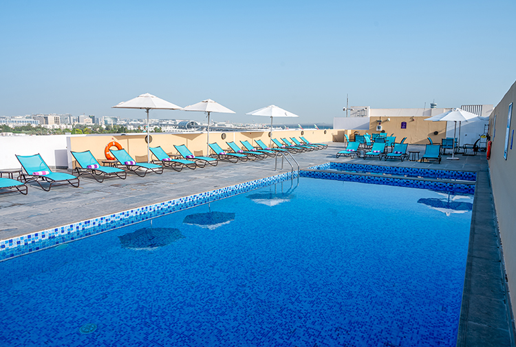 Rooftop swimming pool with airport views and free sunloungers at Premier Inn Dubai International Airport hotel 